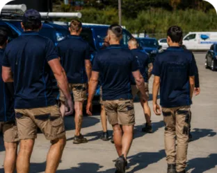 Plumbers walking to their service vans on a Blair Athol job